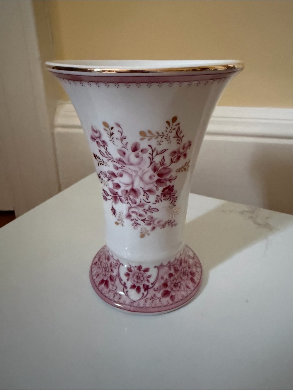 A vintage fluted vase w raspberry floral motif.